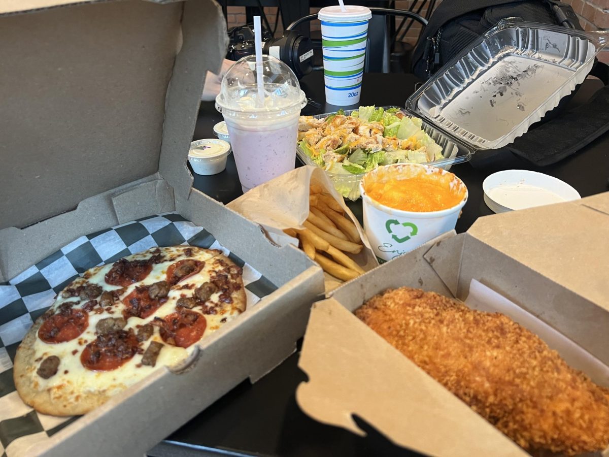 (Front to back) The meat lover's pizza, the jumbo chicken, French fries, Mac and cheese, strawberry milkshake and garden salad from the BERG.