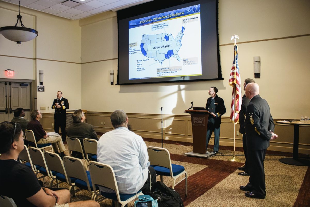 U.S. Navy Officers present facts about shipbuilding in Lawrence Hall.