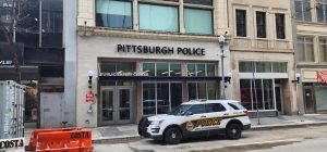 A Pittsburgh police car sits on Wood Street in front of the Public Safety Center.