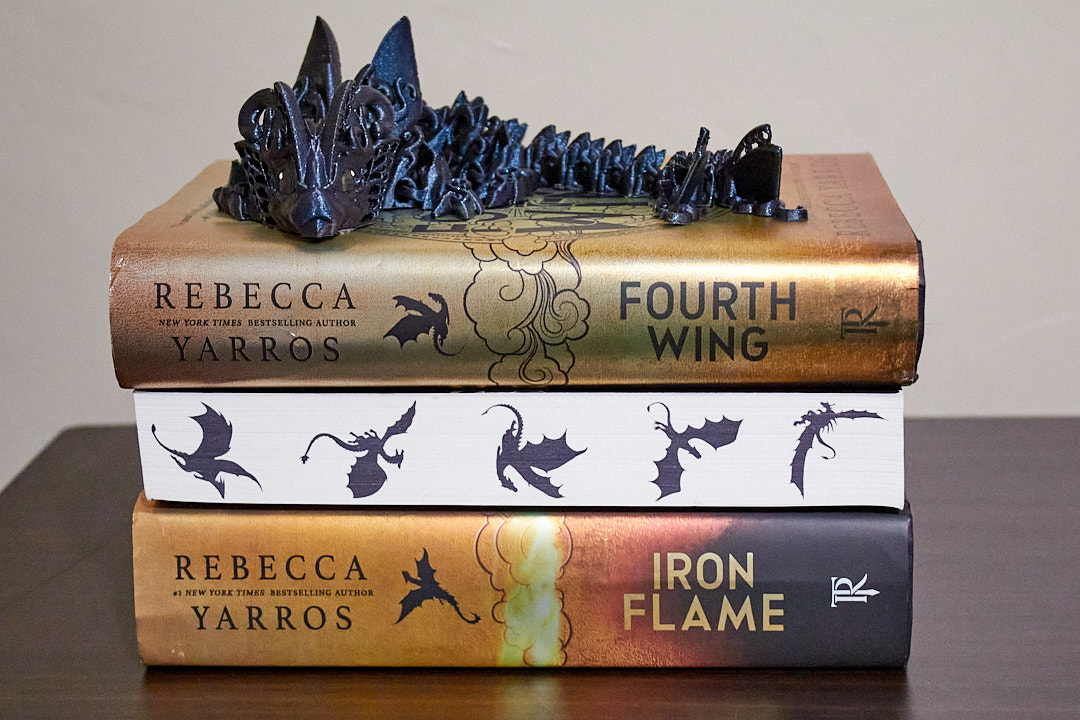 The three books from the Empyrean Book series by Rebecca Yarrow, which she is best known for, sit on a table. 