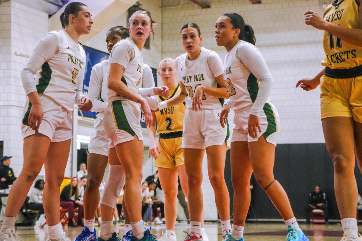 Chloe Williams, Aichata Ballo, Emma Pavalek, Ari Blenda and Alexis Giles huddle between plays versus West Virginia State on Jan.11 at home.