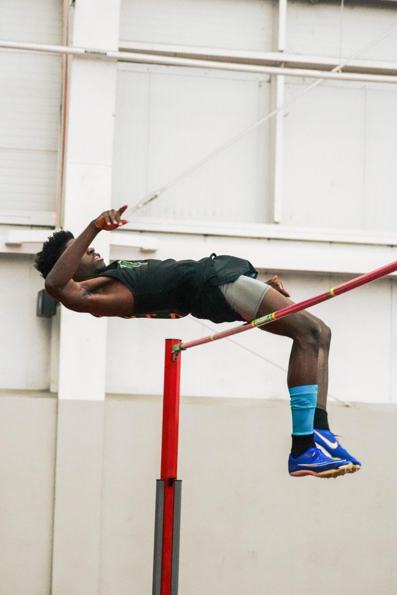 Sophomore Akeem Mustapha clears a jump during the high jump event at the YSU Invitational on Dec. 6.

