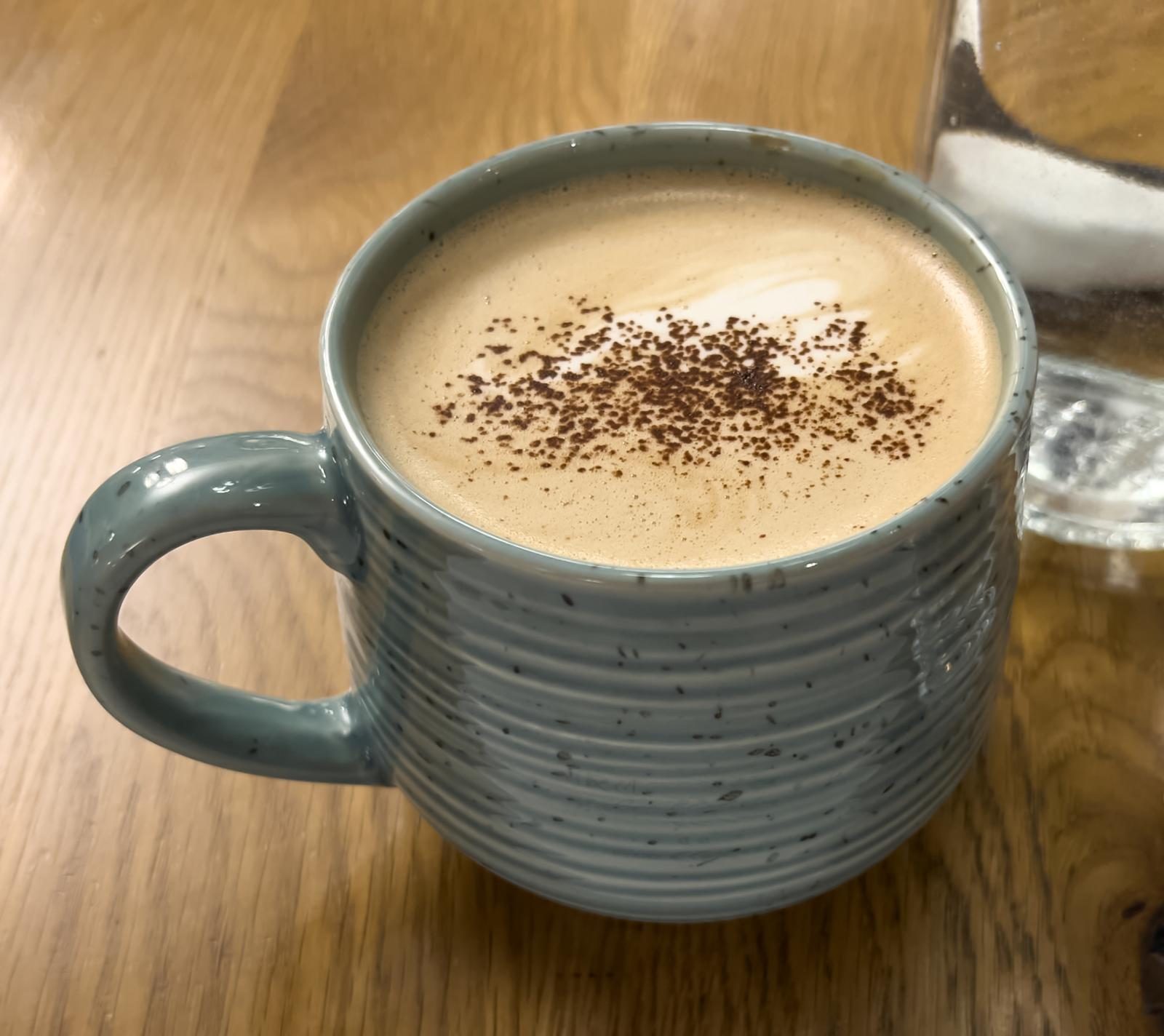 A cup of coffee that costs $5.25 sits on a table at The Speckled Egg inside the Union building Downtown.