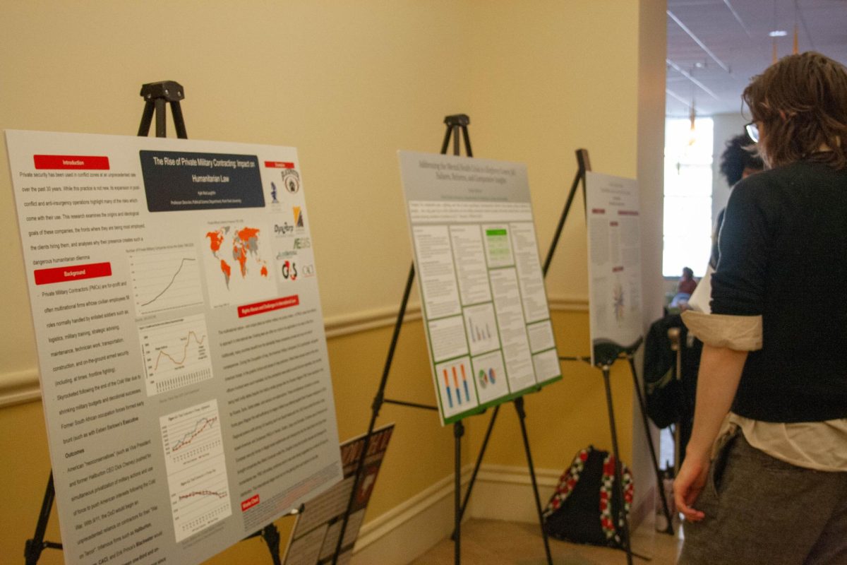 Honors students present their posters to students and staff walking through the Lawrence Hall Lobby.