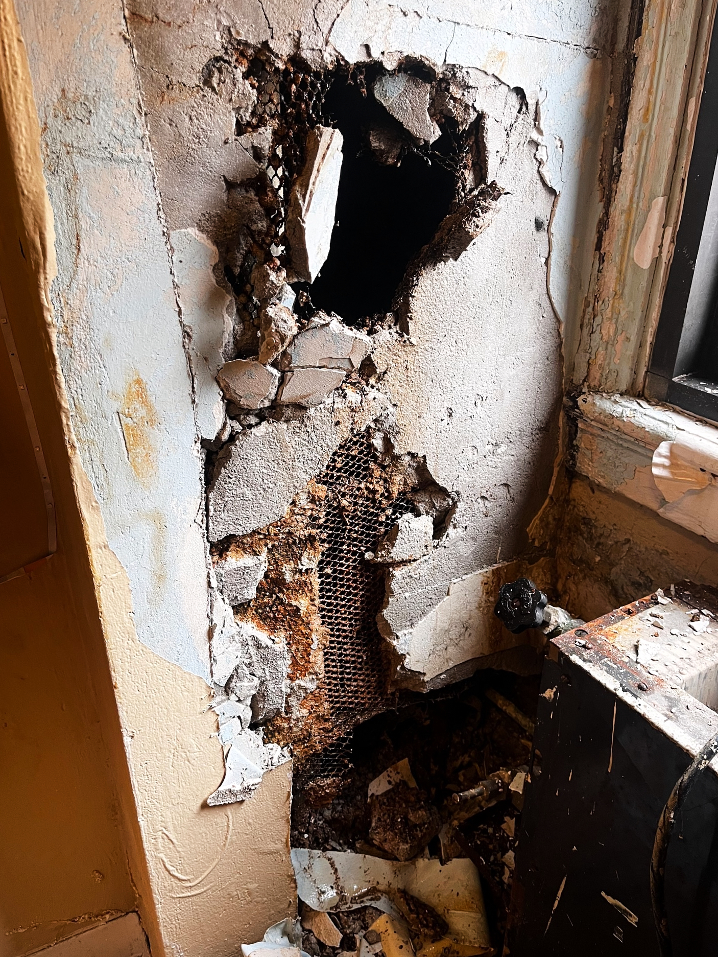 Paint and pieces of the wall left in chunks after maintenance workers created a hole in the wall to access a steam line for the dorm heater.

Submitted by Ayden Miller