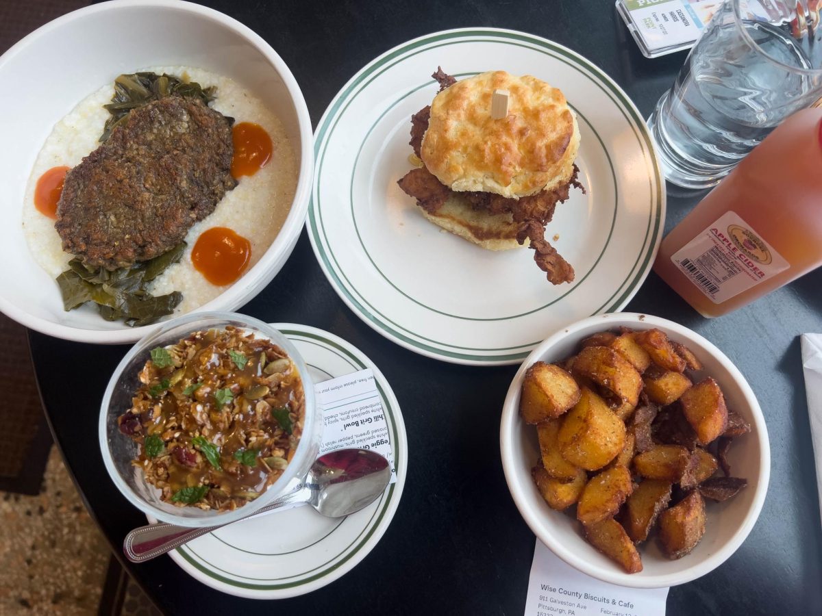 Food from Wise Country Biscuits and Cafe sits on a table. The restaurant is located in Allegheny West. 