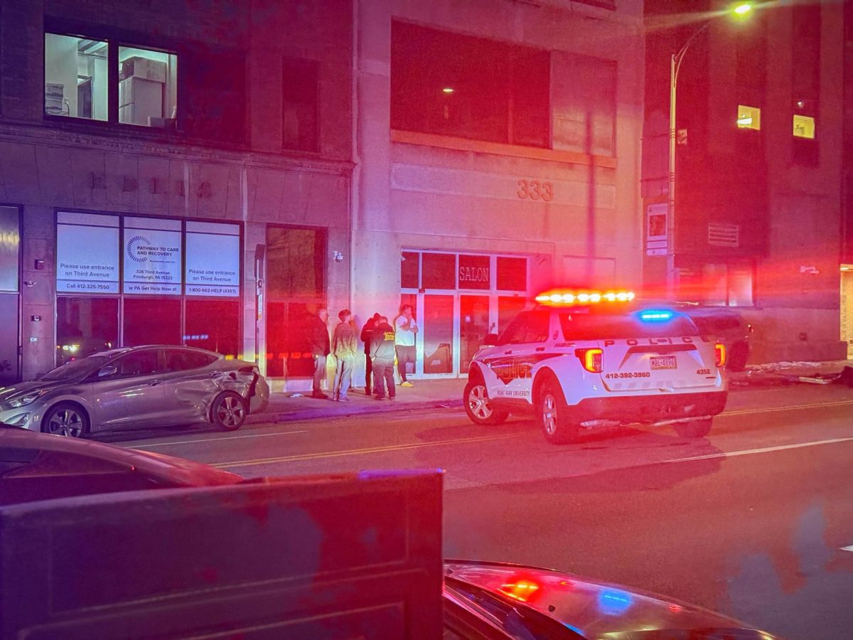 Crash victims and police gather along the side of Boulevard of the Allies as emergency responders rescue trapped passengers. 