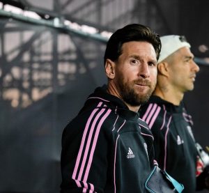 Lionel Messi walks into the stadium, looking directly at my camera as he prepares for the match.