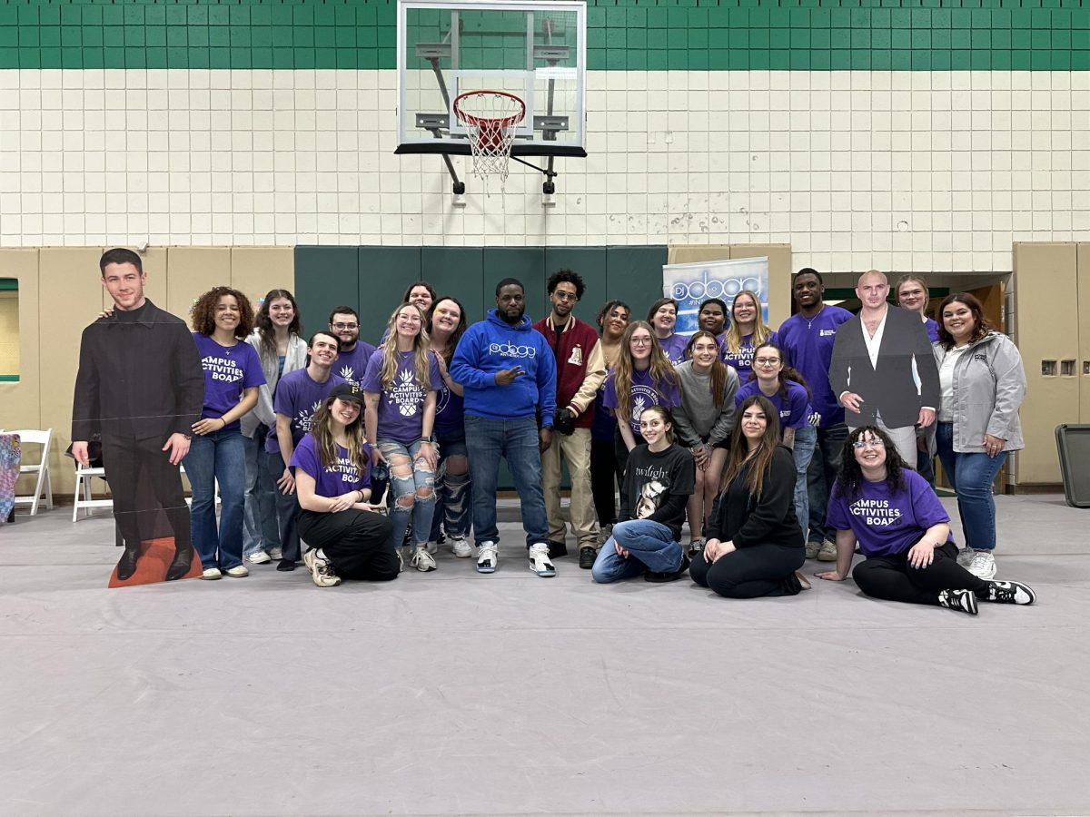 Members of the Campus Activities Board pose with cardboard cutouts of Disney actors along with guests DJ PDogg and Matthew Finley.
Courtesy of CAB