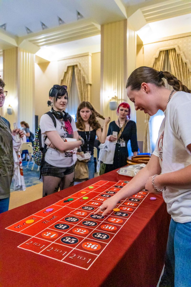 Money is thrown about while students “gamble” for free prizes.