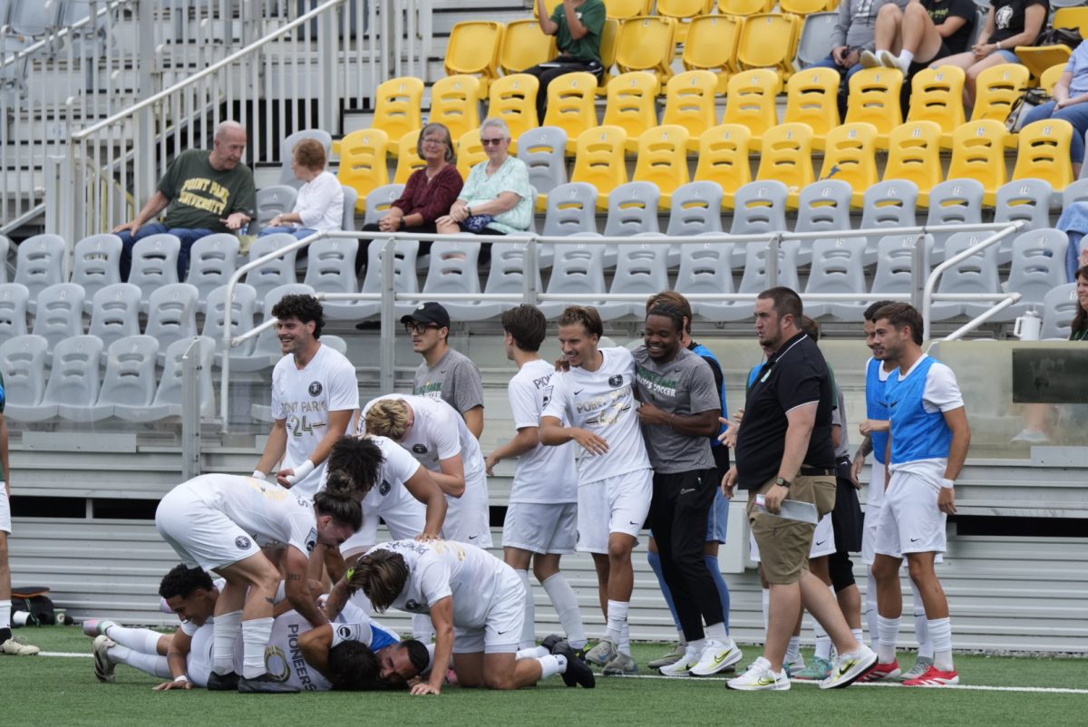The men's soccer team celebrates Lorenzo Grispello's first goal of the season on the sidelines on Saturday.