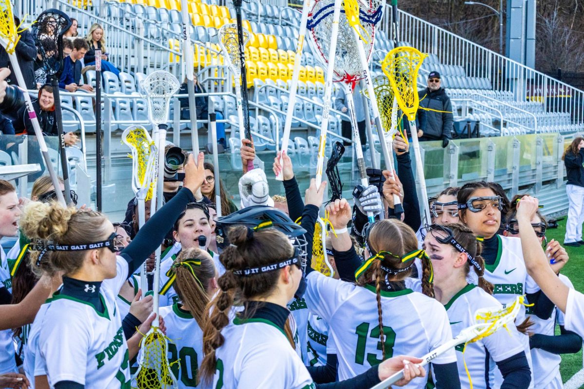 Women’s lacrosse concludes a huddle during a timeout on Feb. 21 at Highmark Stadium.