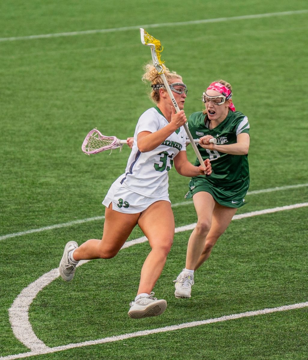 Ava Miller runs down the field against Malone University.