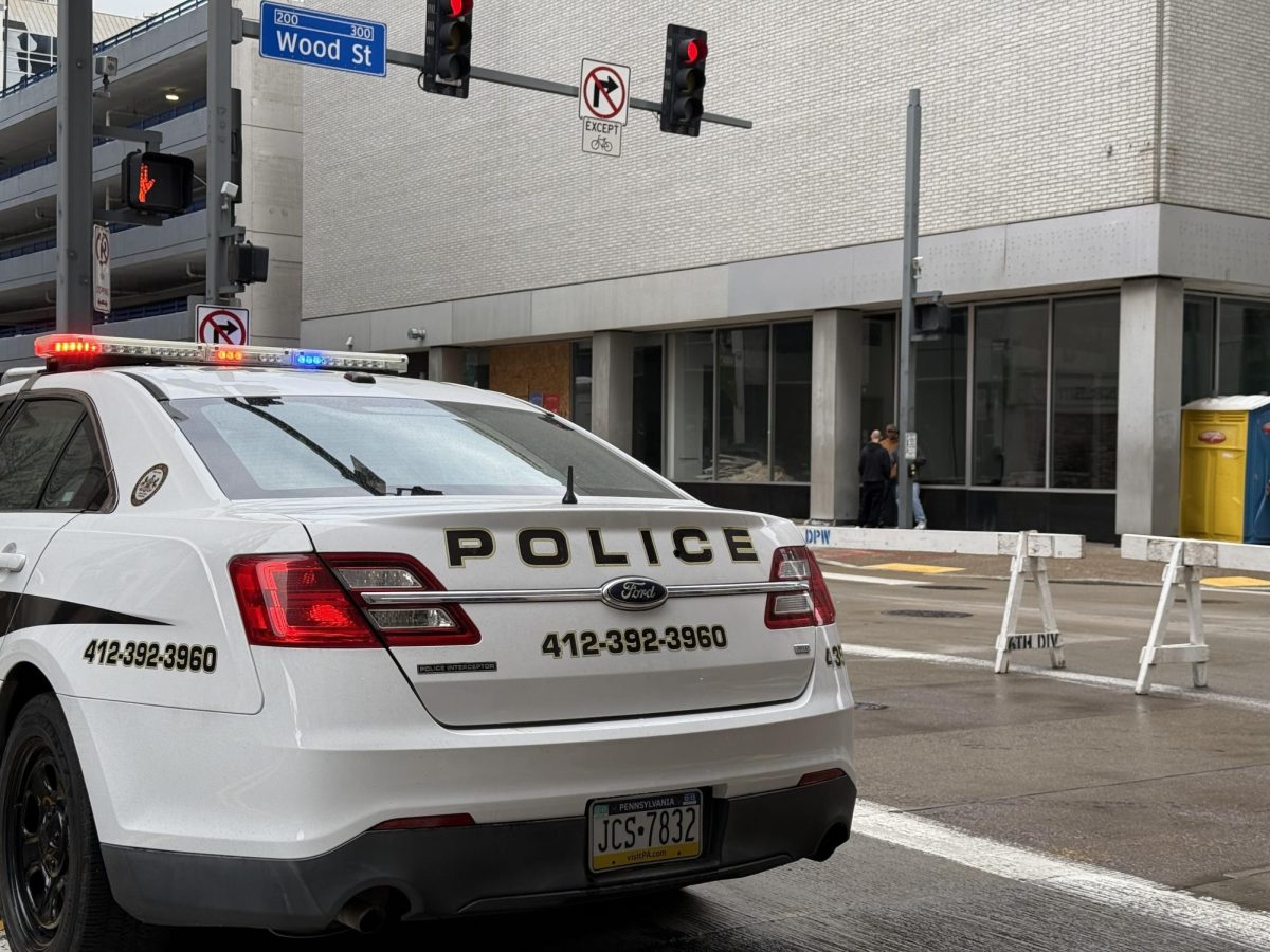 A Point Park Police car blocks Wood Street during a St. Patrick's Day parade.