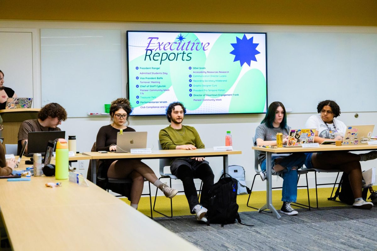 Graphic Designer Liv Curti, President Christian Rangel and Sen. Aylah Hildebrand discuss business during Monday’s SGA meeting.