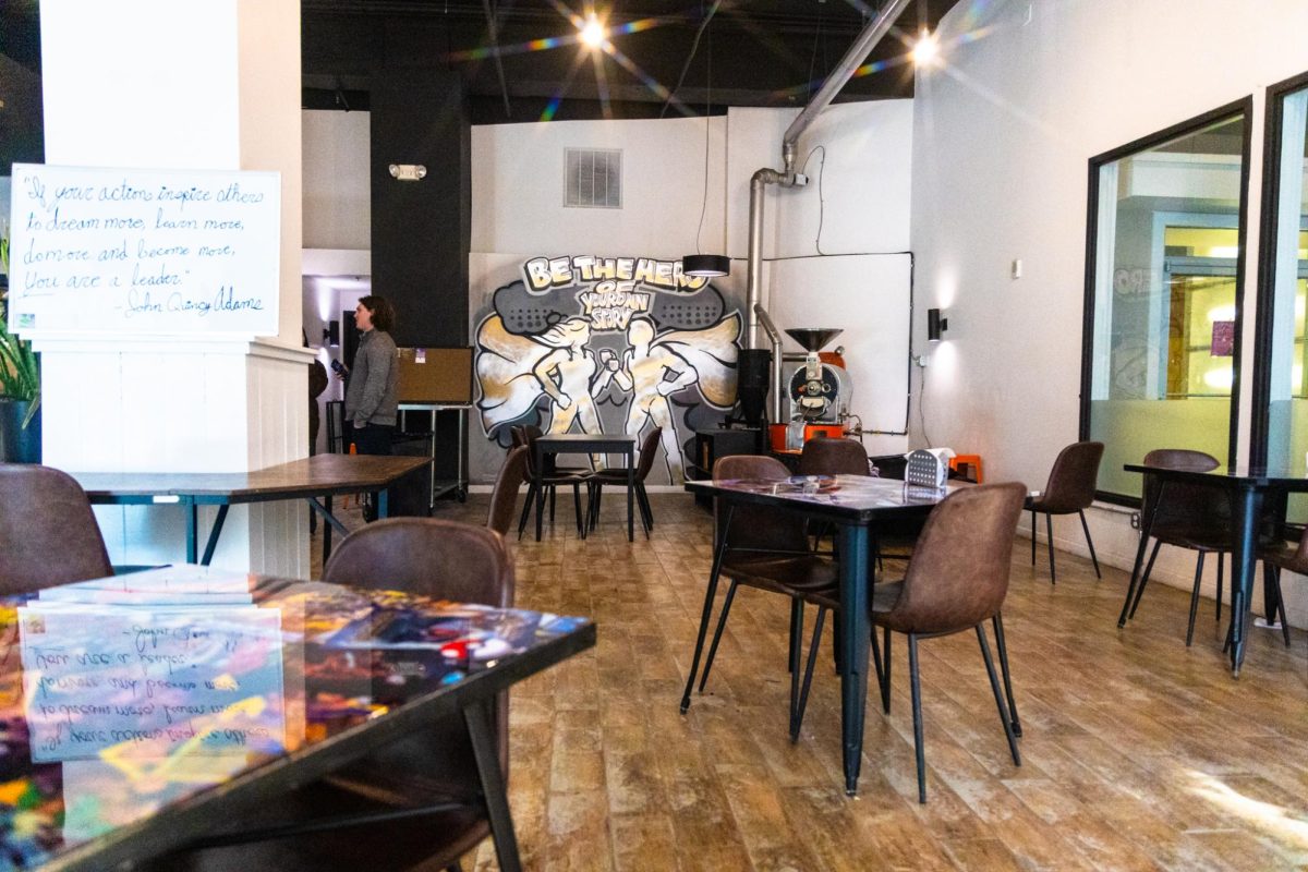 The interior of Origin Story coffee on Smithfield Street, which is adorned with various superhero themed visuals.