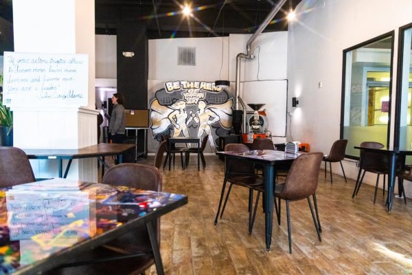 The interior of Origin Story coffee on Smithfield Street, which is adorned with various superhero themed visuals.