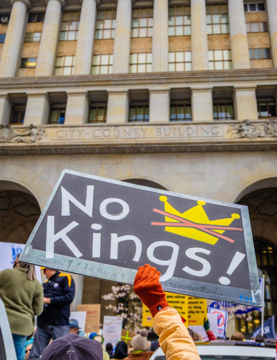 A protestor holds a sign at the most recent “No Kings” rally on March 28.